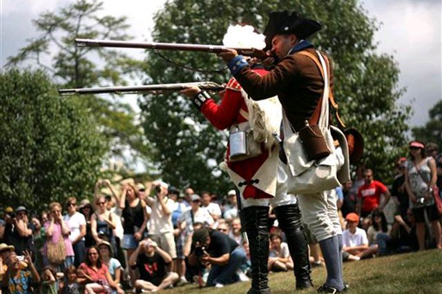Re-enactors firing their weapons during a simulation of the Battle of Brooklyn.